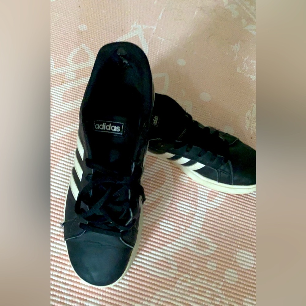 Adidas sneakers, wear and tear on inside back of ankle. Good condition.